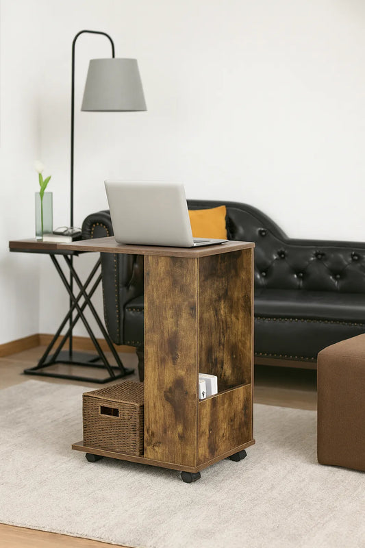 Wooden side table with laptop, lamp, and black sofa in a living room setting