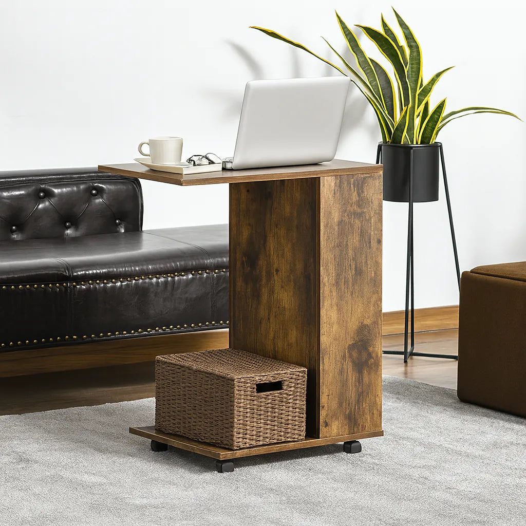 Wooden side table with laptop, cup, and plant in a living room setting.