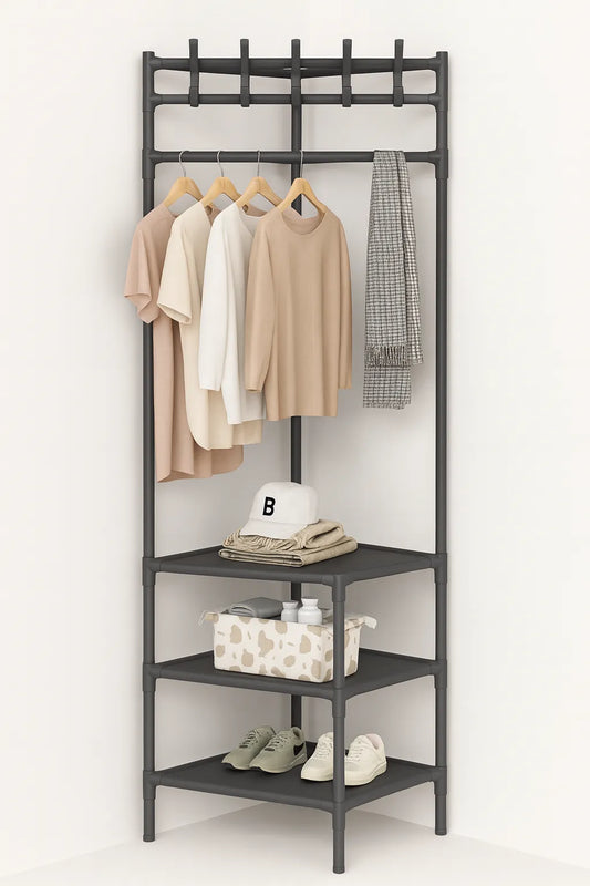 Black metal clothing rack with clothes, shoes, and a box on a white background