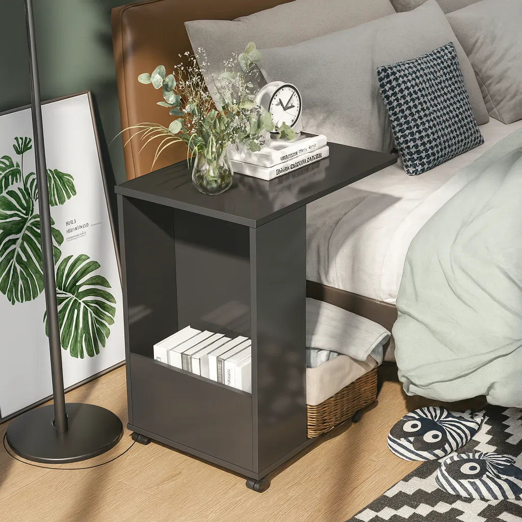 Black nightstand with decorative items next to a bed