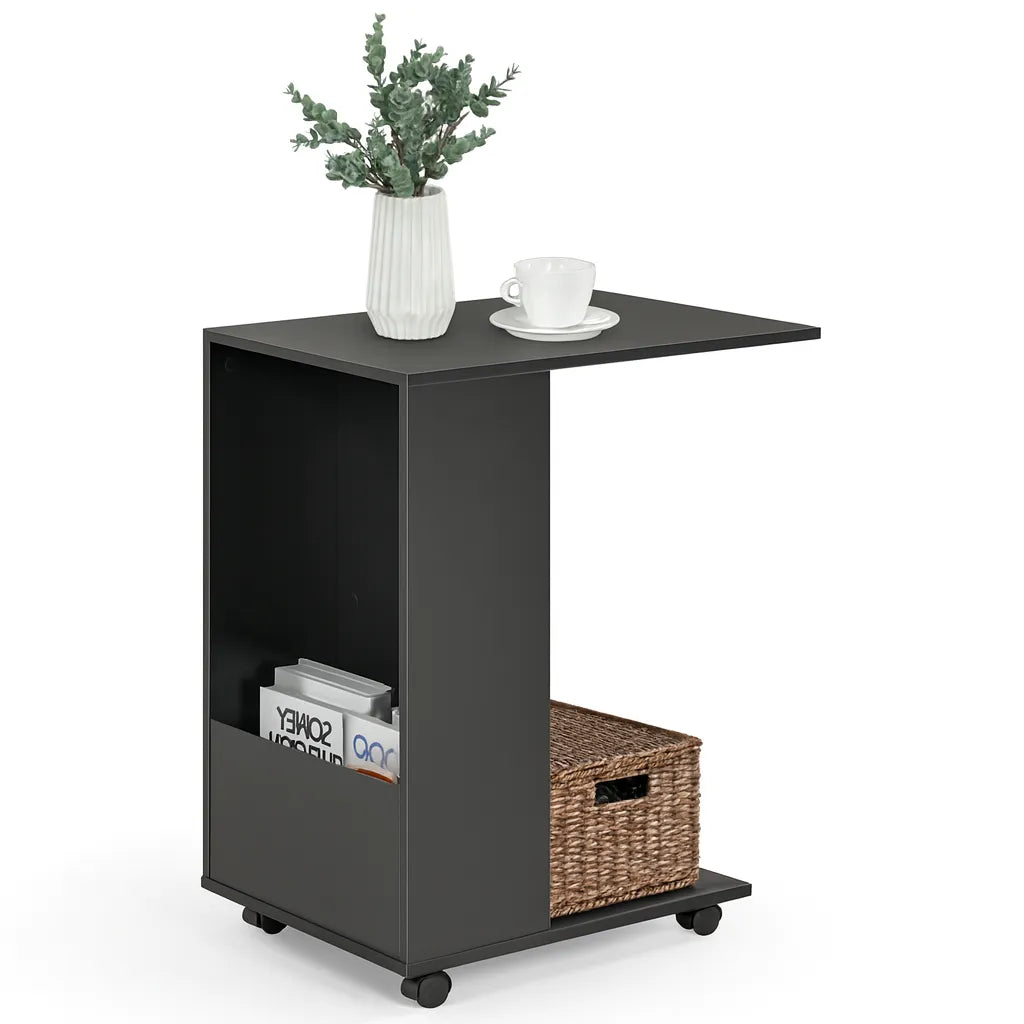 Black side table with a wicker basket, books, and a cup on a white background