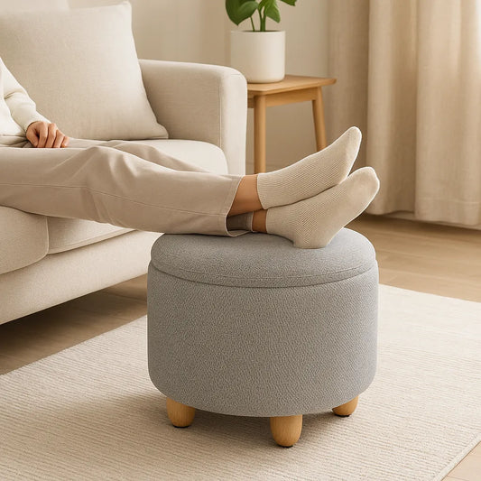 Person relaxing with feet on a gray ottoman in a cozy living room.
