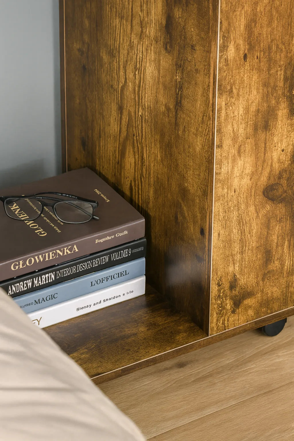Stack of books on a wooden shelf with a blurred background