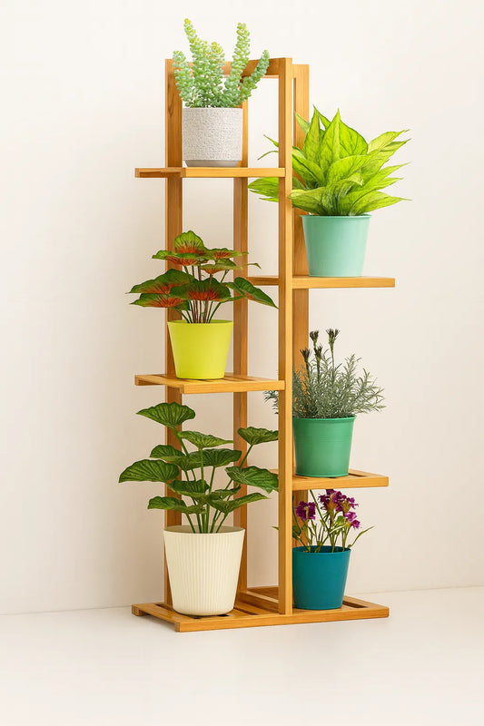 Wooden plant stand with various potted plants on a white background