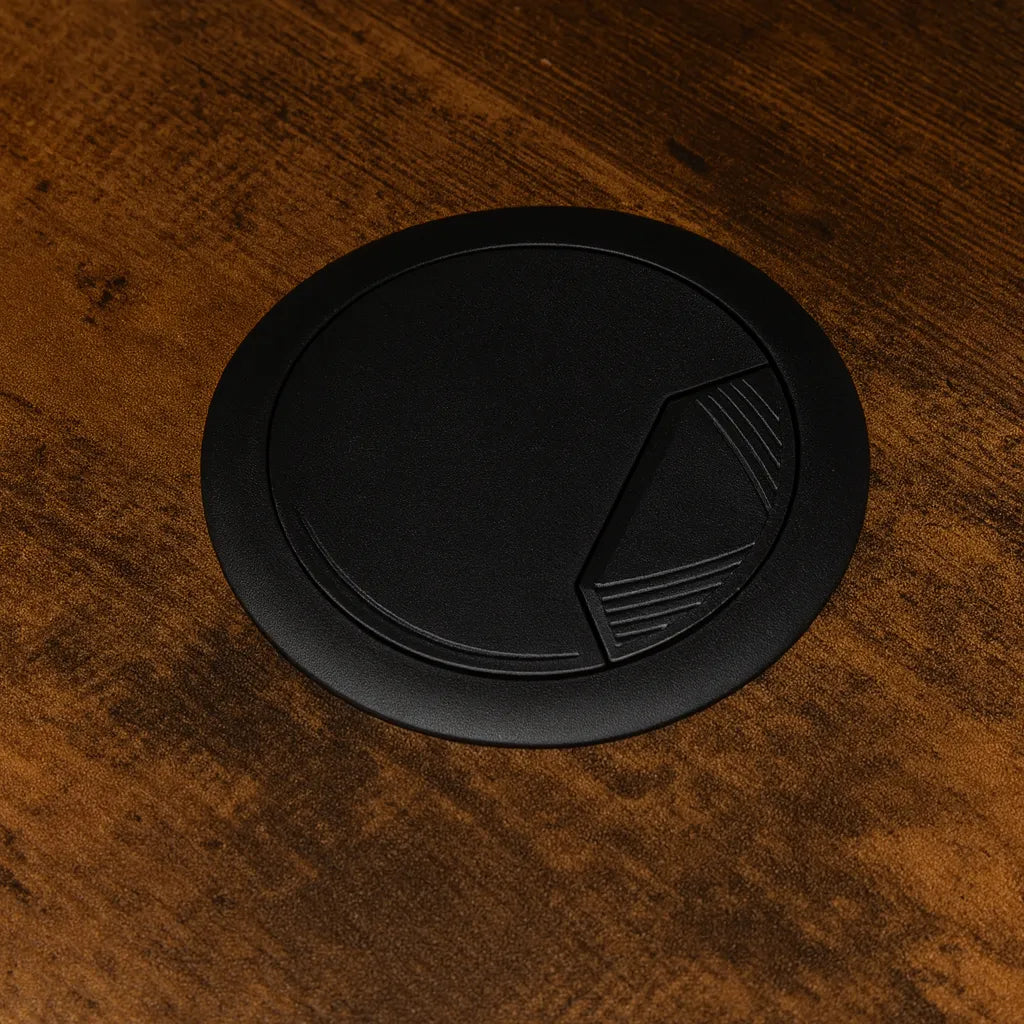 Black circular object with geometric design on a wooden surface